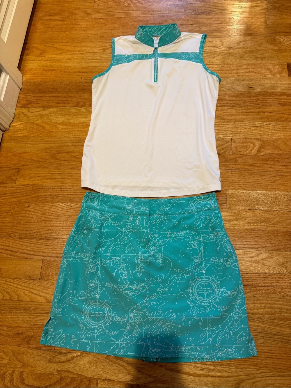 Izod Golf 2-piece outfit- White Sleeveless Polo with Teal Printed A-Line Skirt
